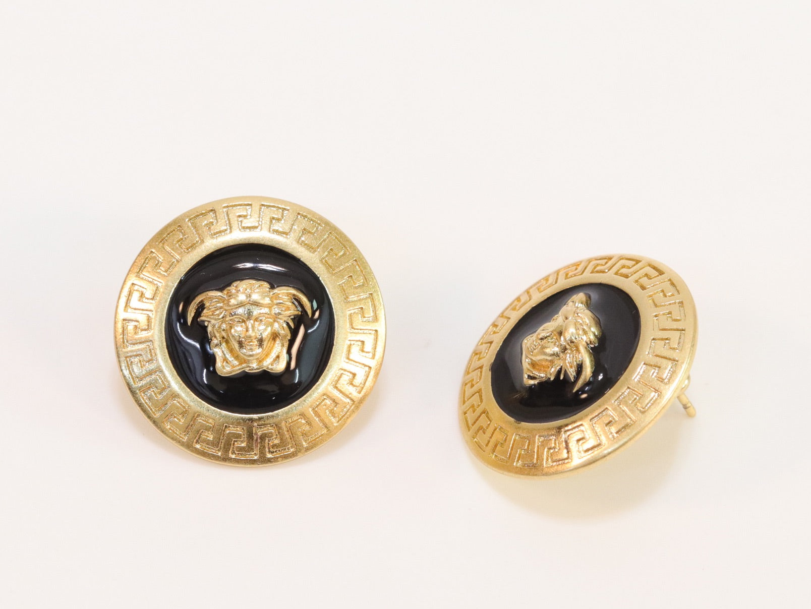 Gold round medusa motif black enamel earrings