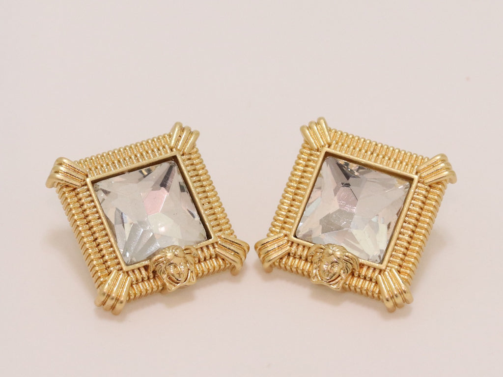 Square solitaires in gold boundaries with medusa