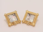 Square solitaires in gold boundaries with medusa