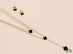Dual chain necklace with black onyx clovers in gold finish