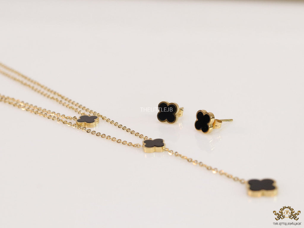 Dual chain necklace with black onyx clovers in gold finish
