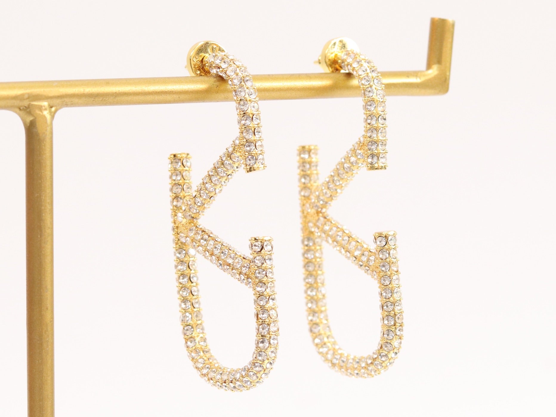 Open golden alphabet V earrings with cz 62 mm