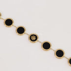 Gold plated chain bracelet with T motif on black enamel coating