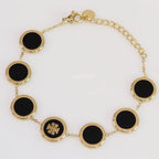 Gold plated chain bracelet with T motif on black enamel coating