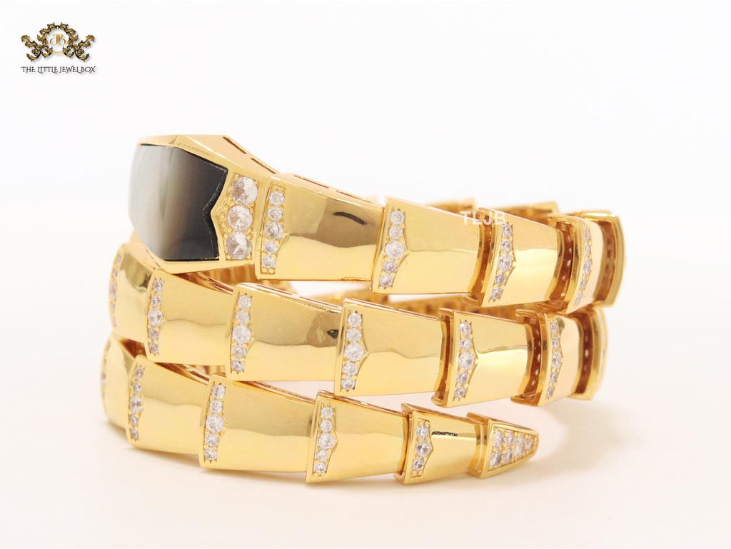 Bold gold and cz snake bracelet with black mop head