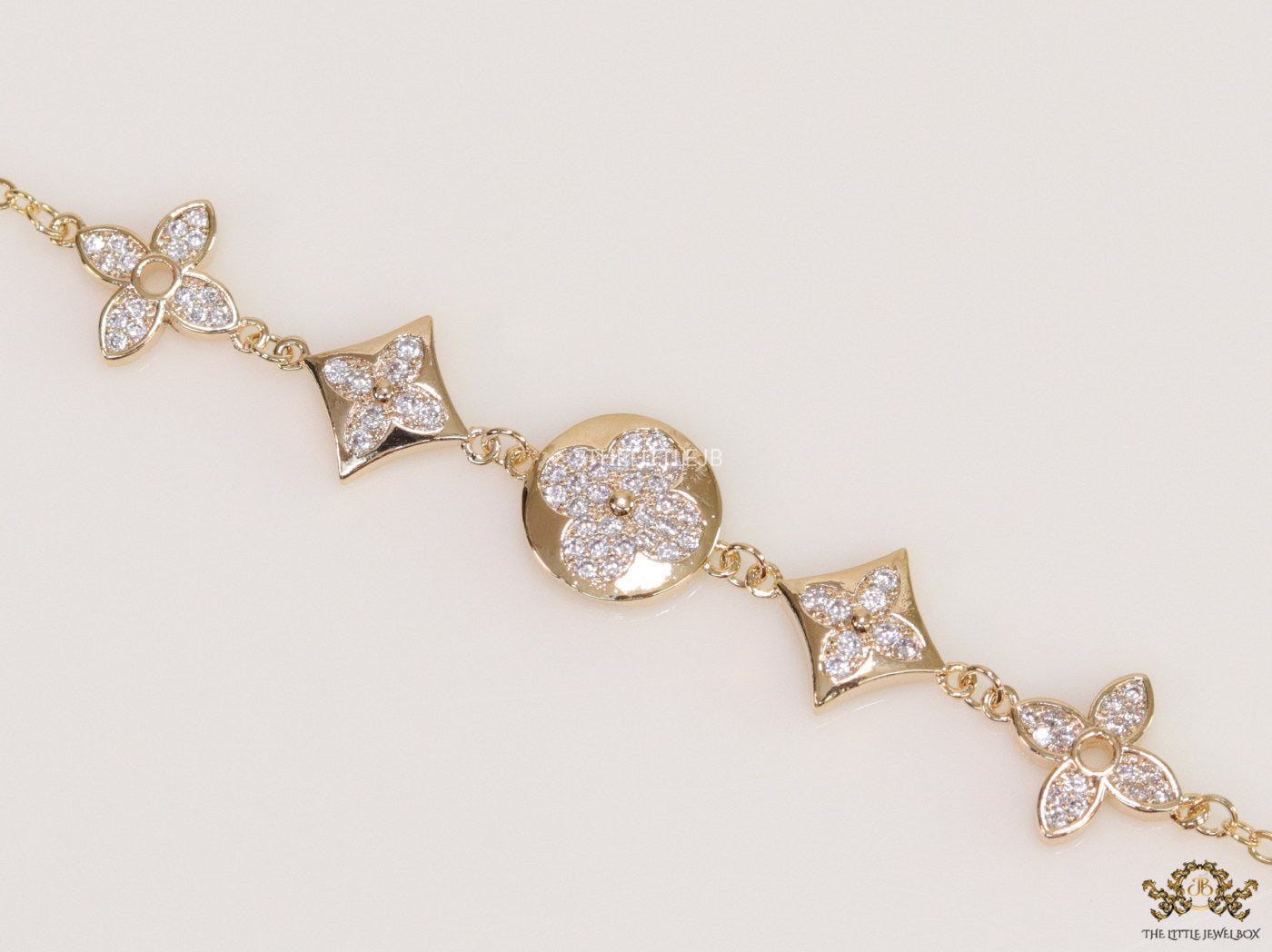 Gold plated chain bracelet with cz clovers and flowers