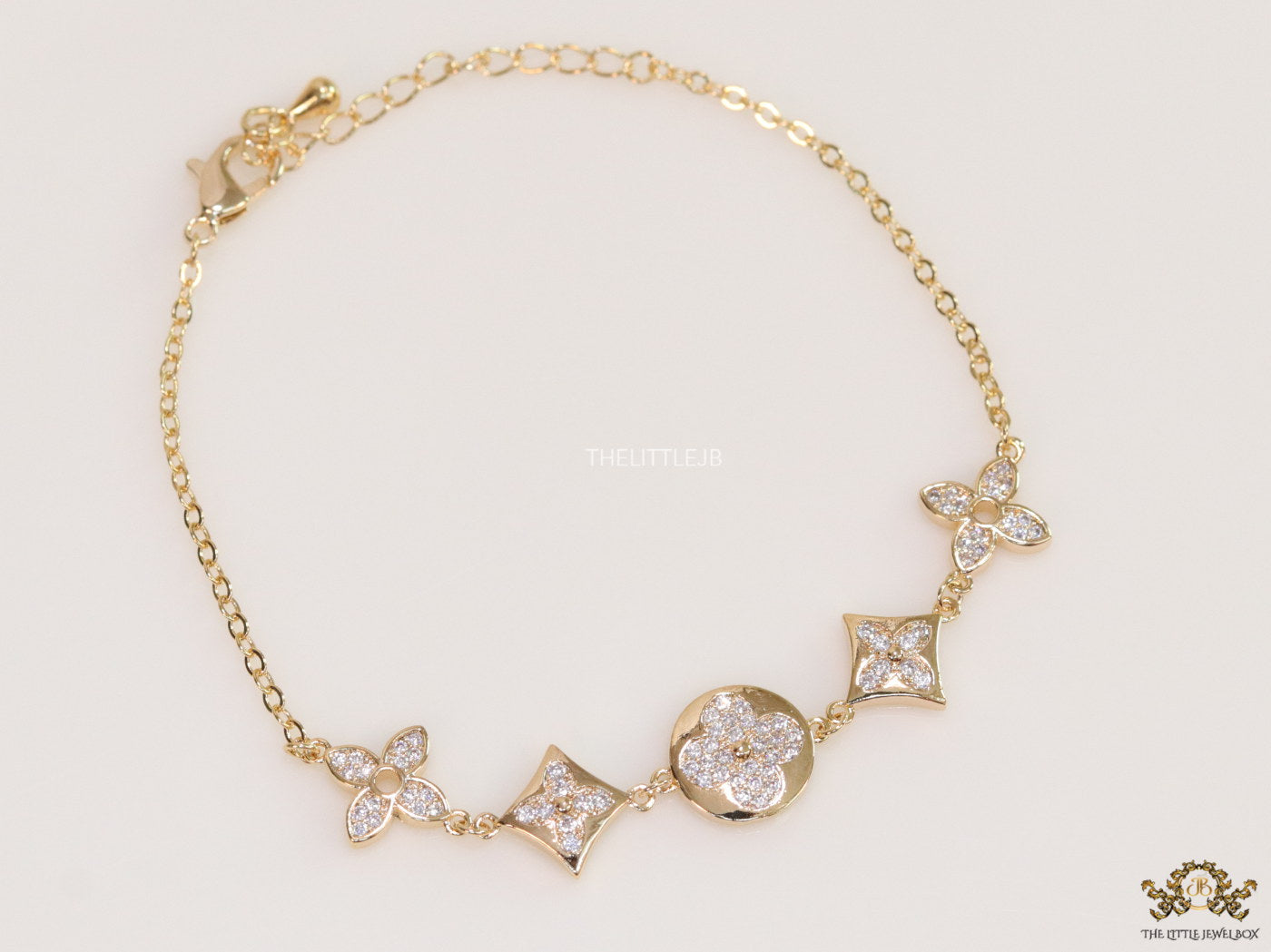 Gold plated chain bracelet with cz clovers and flowers