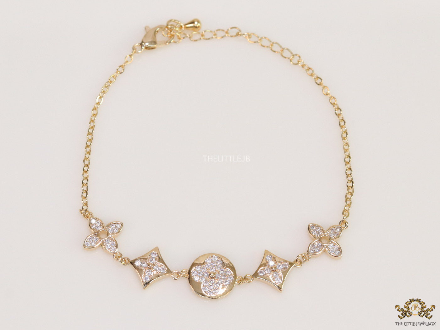 Gold plated chain bracelet with cz clovers and flowers