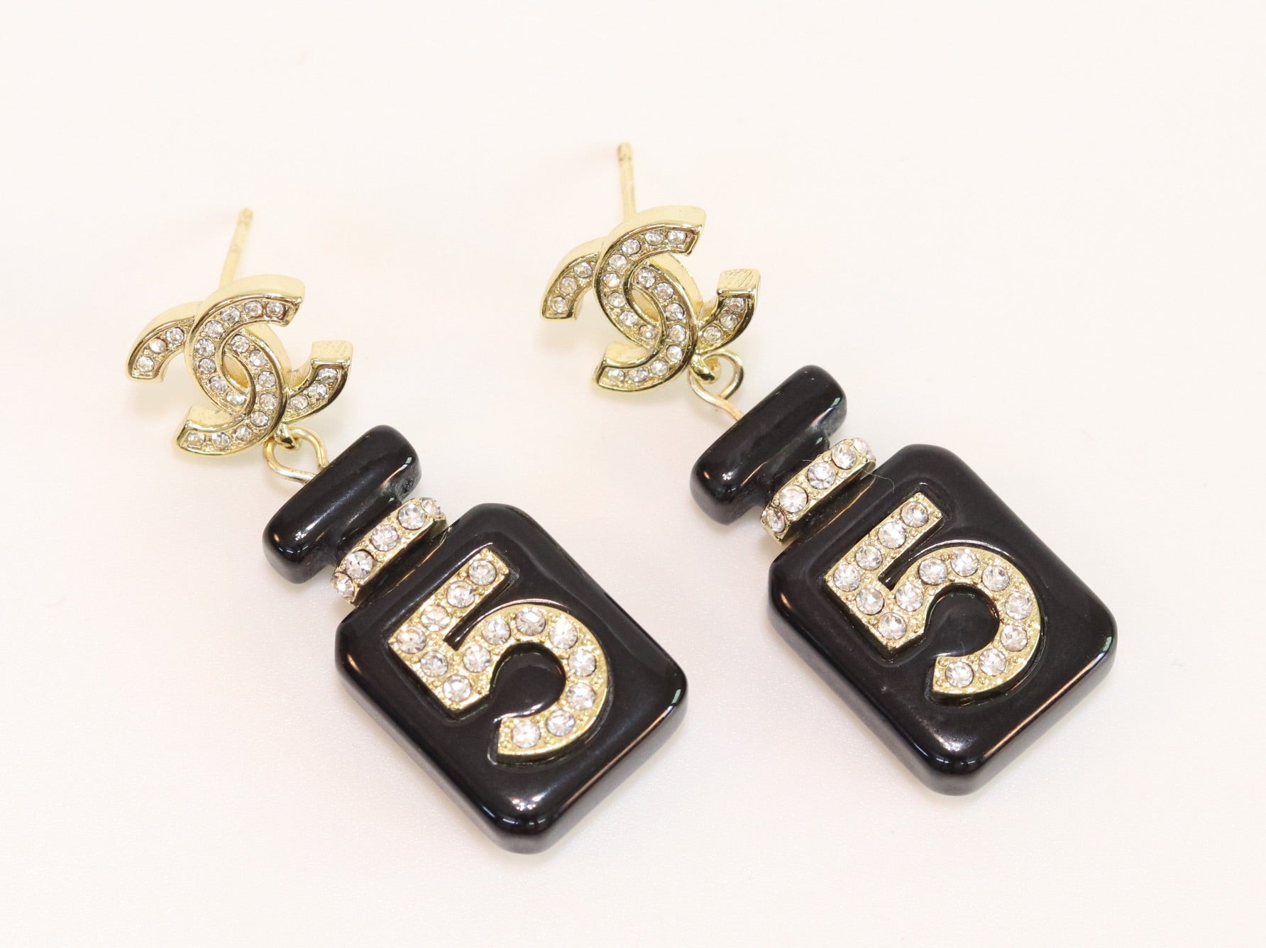 Double C gold danglers with 5 in CZ on black enamel