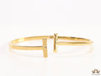 Gold plated bracelet with T motif centre