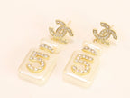 Double C gold danglers with 5 in CZ on white enamel