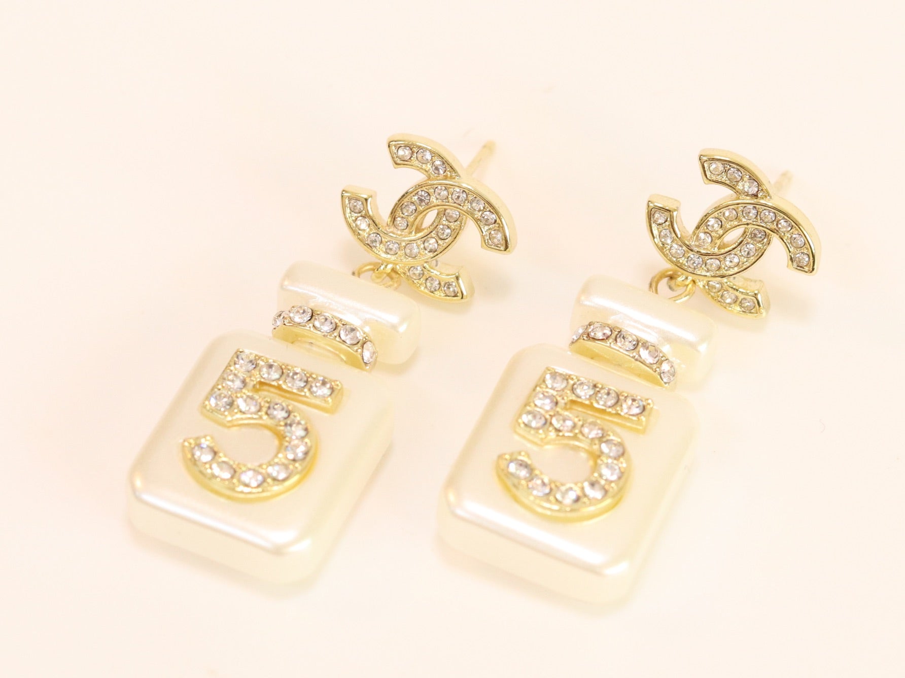 Double C gold danglers with 5 in CZ on white enamel