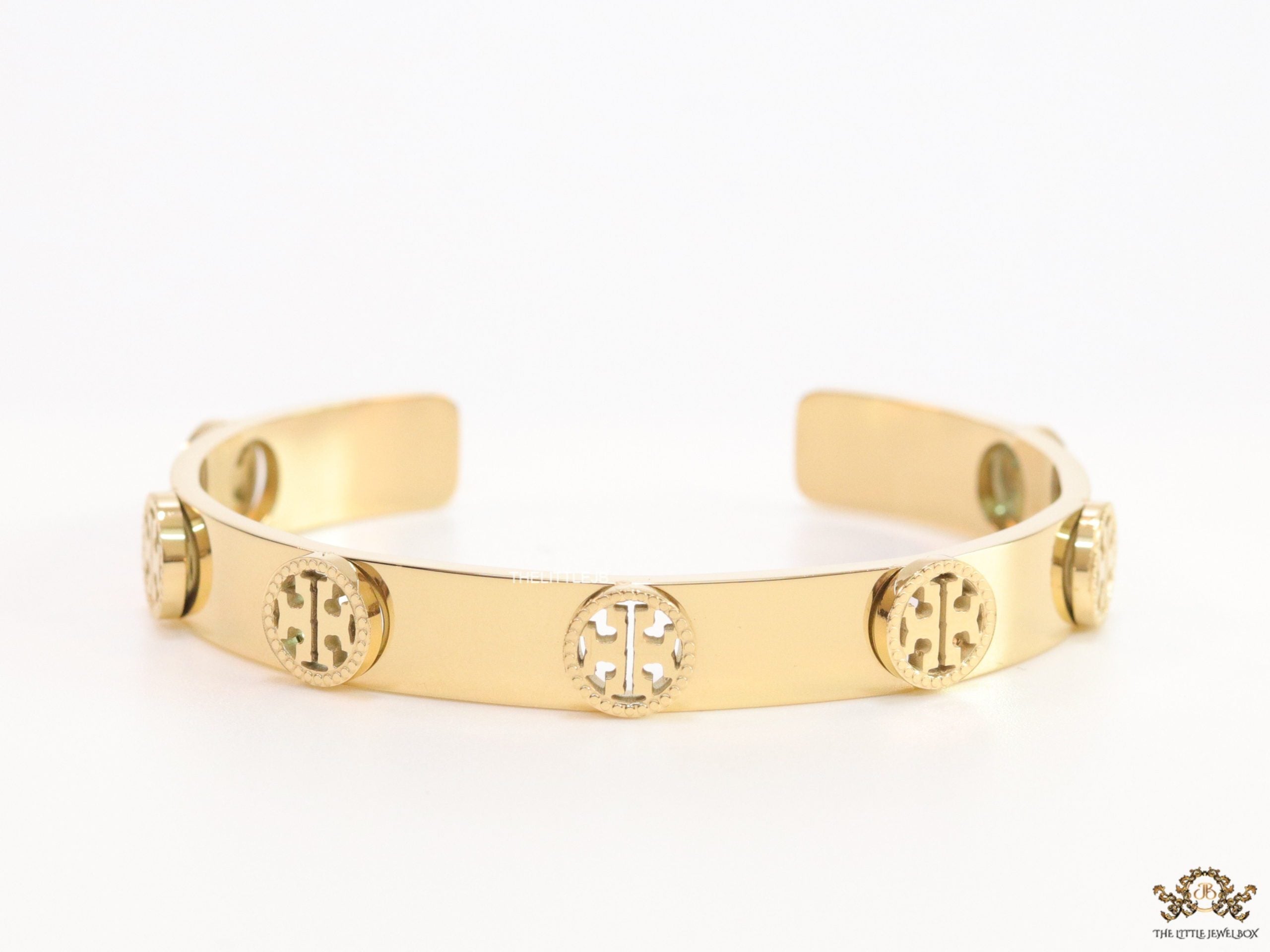 Gold plated open band bracelet with twin T motifs