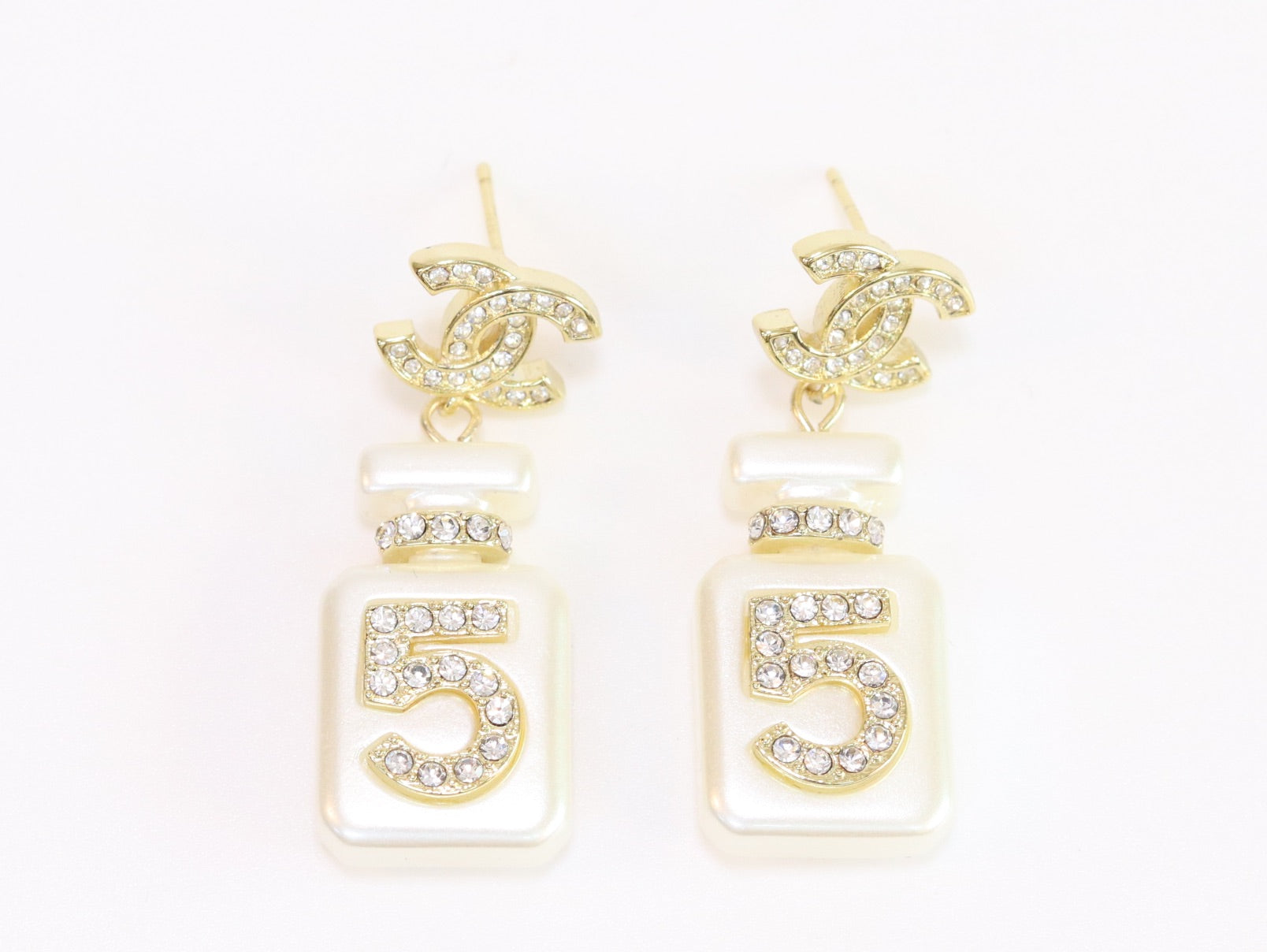 Double C gold danglers with 5 in CZ on white enamel