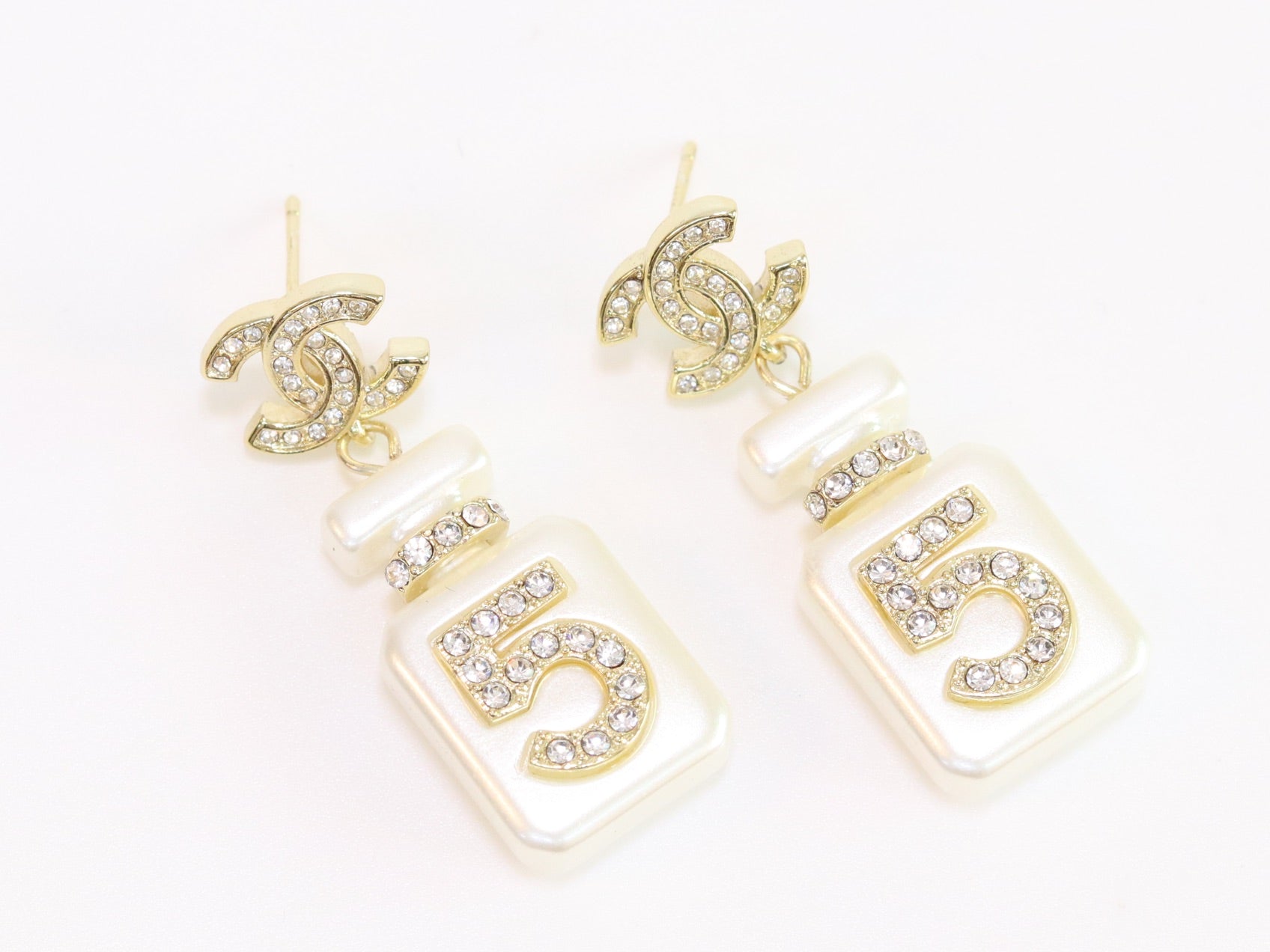 Double C gold danglers with 5 in CZ on white enamel