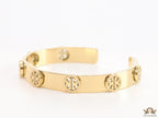 Gold plated open band bracelet with twin T motifs