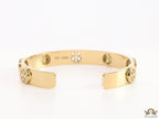 Gold plated open band bracelet with twin T motifs