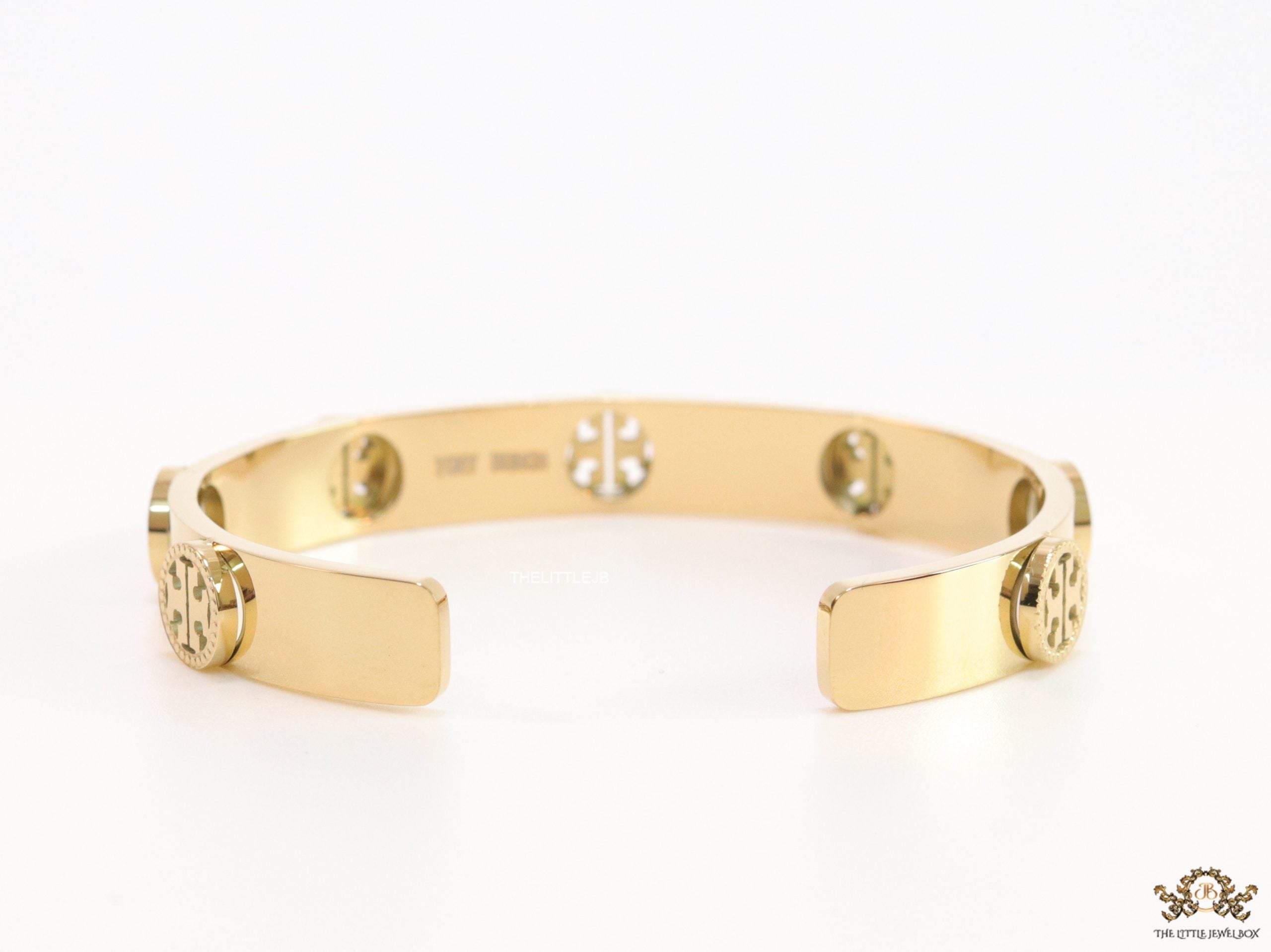 Gold plated open band bracelet with twin T motifs