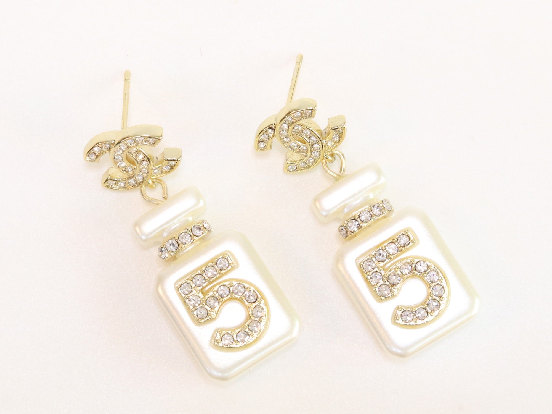 Double C gold danglers with 5 in CZ on white enamel