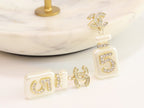 Double C gold danglers with 5 in CZ on white enamel
