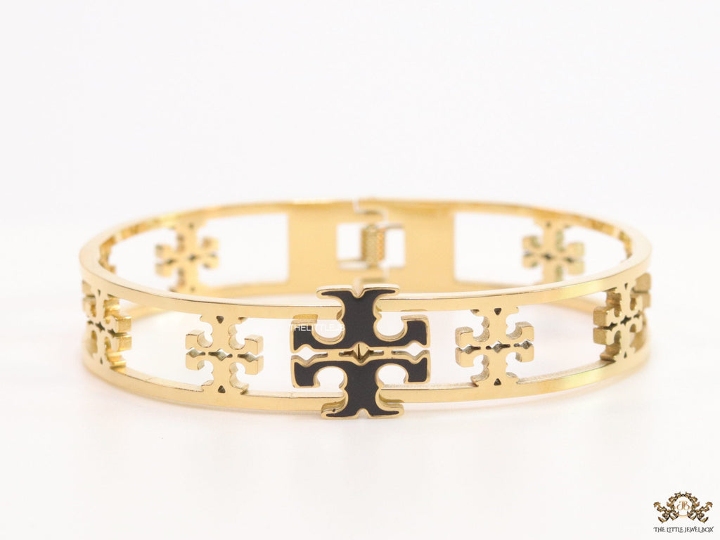 Gold plated openable bracelet with fancy cutwork T motifs