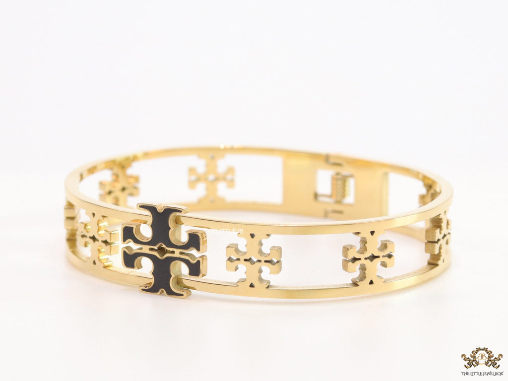 Gold plated openable bracelet with fancy cutwork T motifs