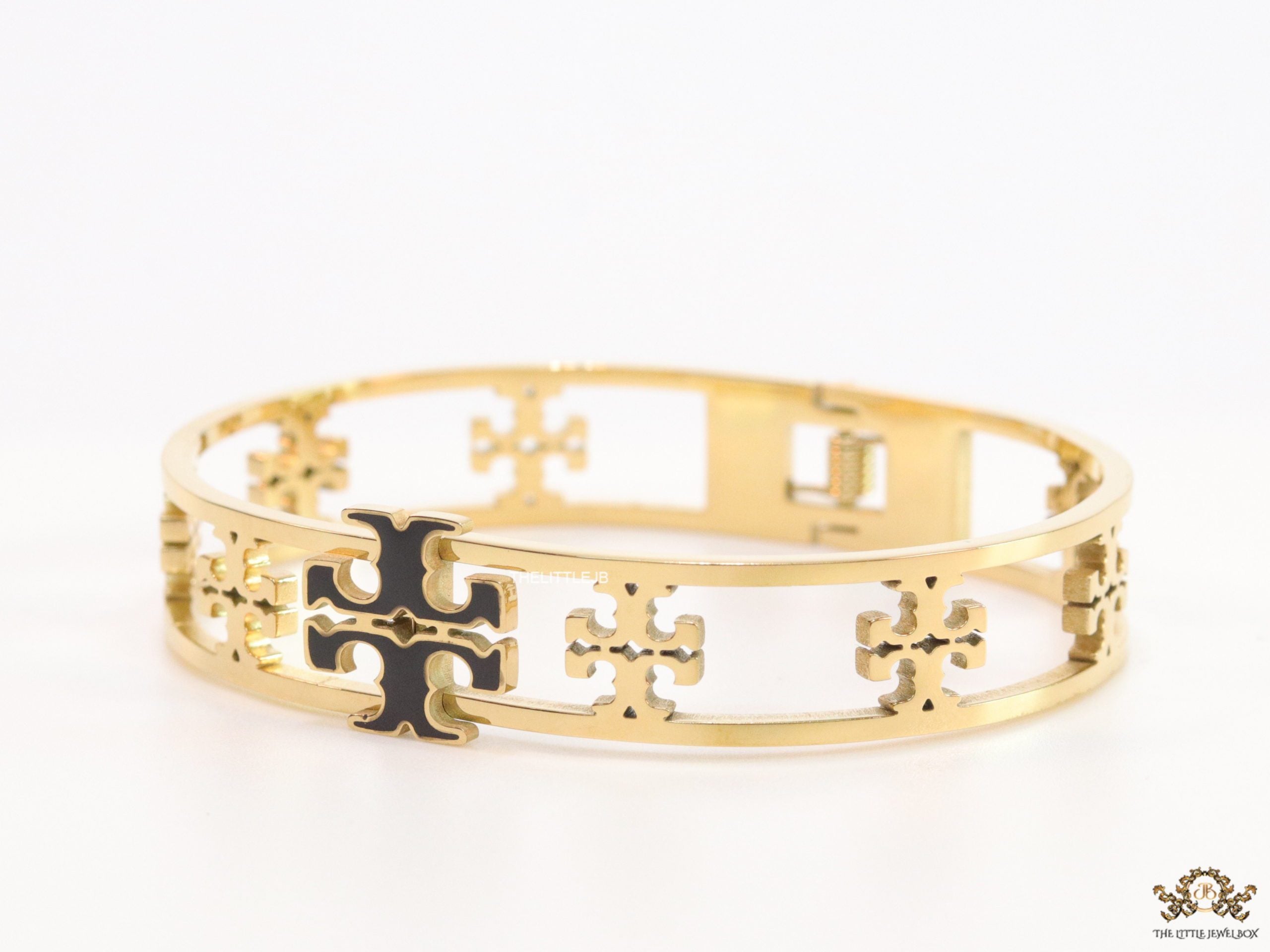 Gold plated openable bracelet with fancy cutwork T motifs
