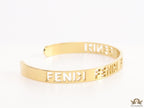 Gold plated open band bracelet with cutwork alphabets