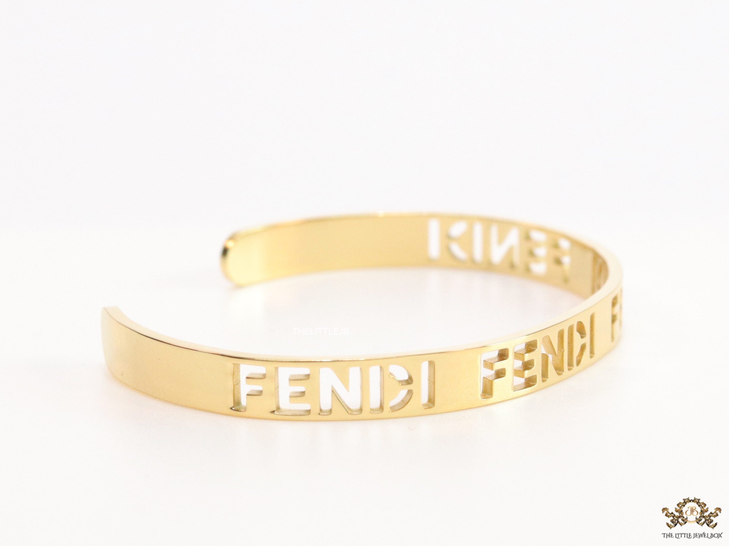 Gold plated open band bracelet with cutwork alphabets