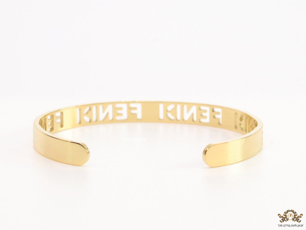 Gold plated open band bracelet with cutwork alphabets