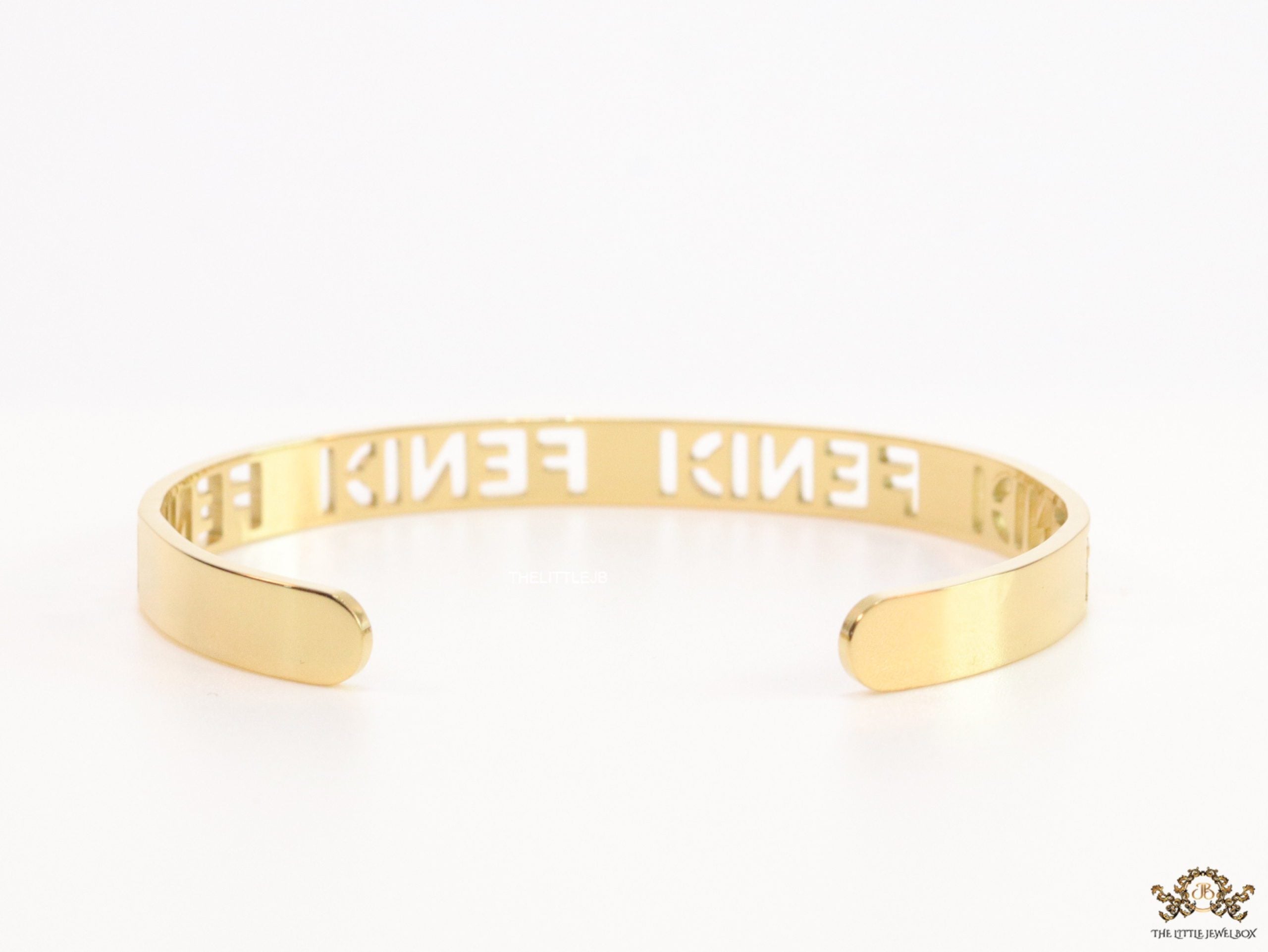 Gold plated open band bracelet with cutwork alphabets