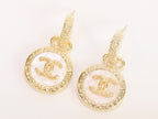 Double C on white enamel hanging gold earrings with CZ