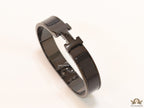 Broad black bracelet with H alphabet in centre
