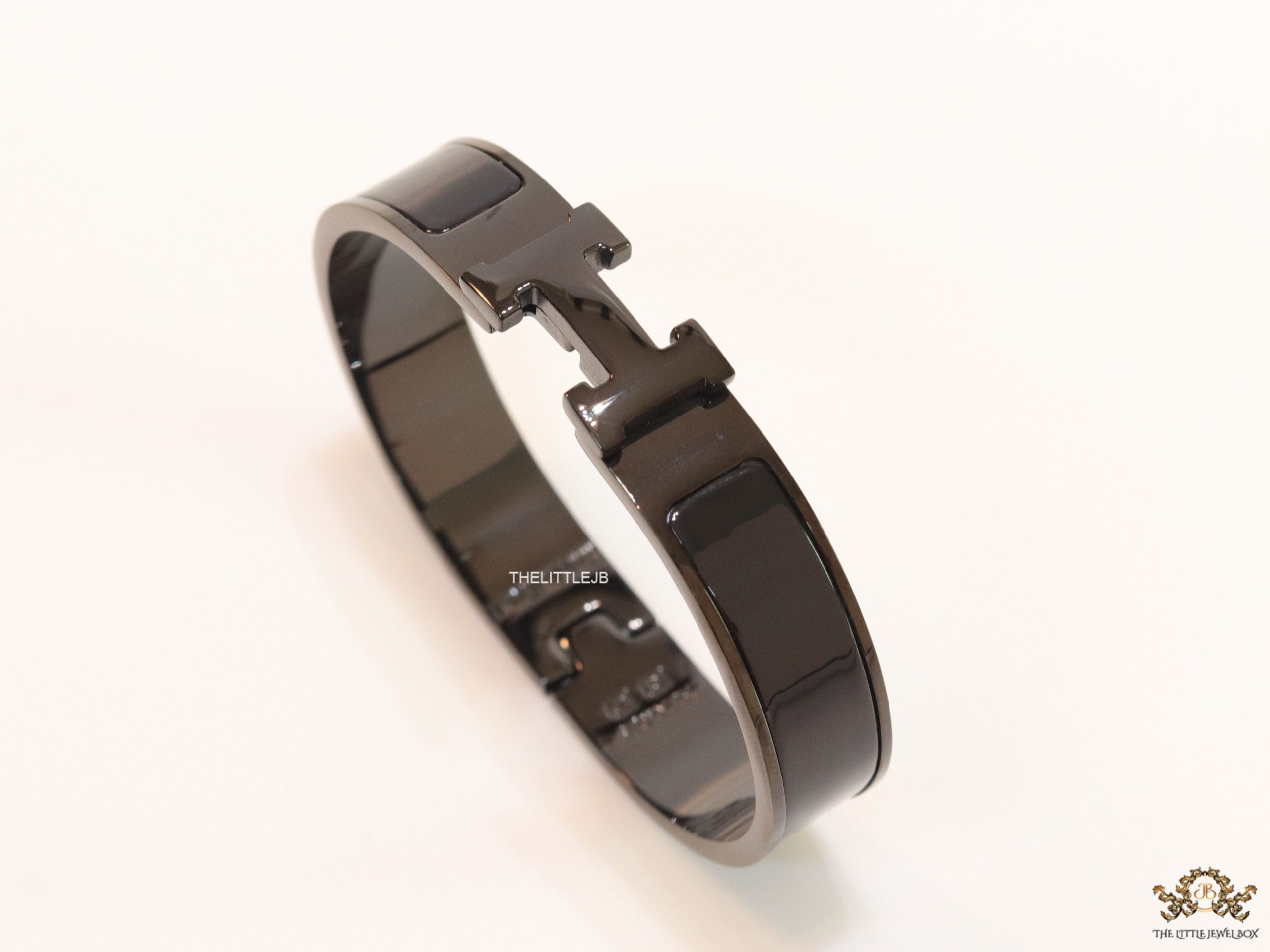 Broad black bracelet with H alphabet in centre