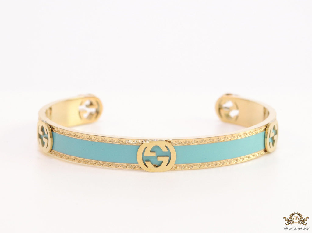 Blue and golden open band bracelet with twin G alphabet motifs
