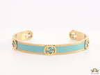 Blue and golden open band bracelet with twin G alphabet motifs