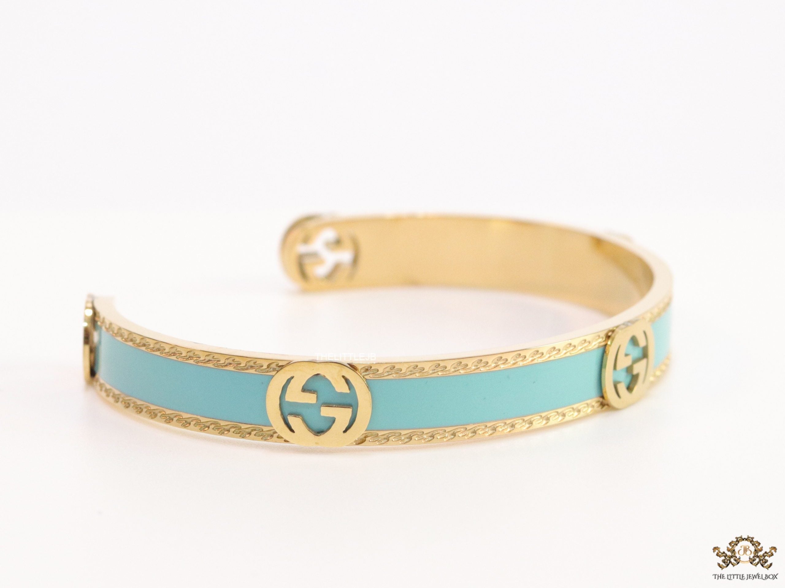Blue and golden open band bracelet with twin G alphabet motifs