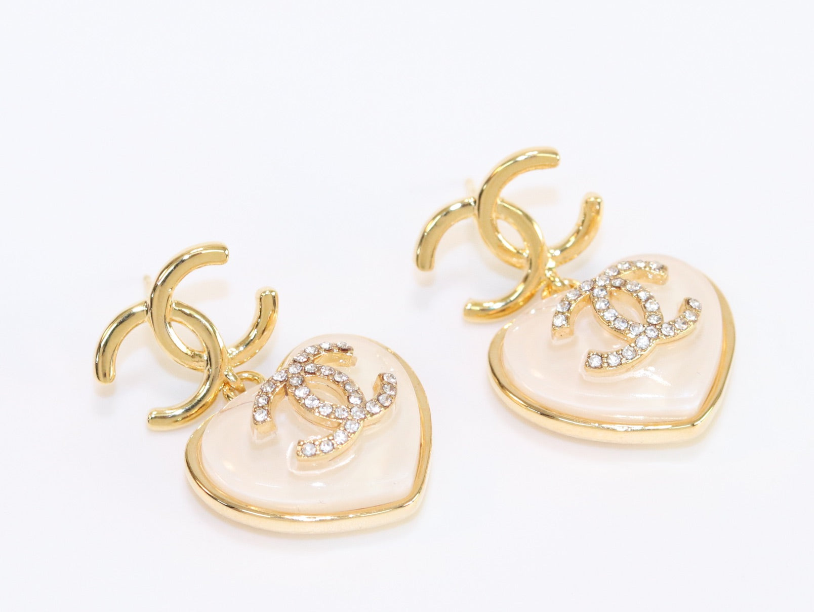 Double C on dangling cream heart gold earrings with CZ