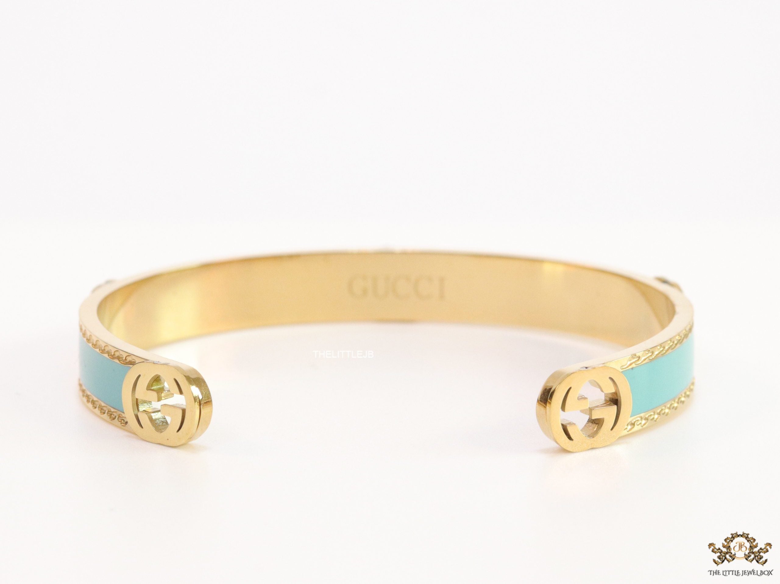 Blue and golden open band bracelet with twin G alphabet motifs