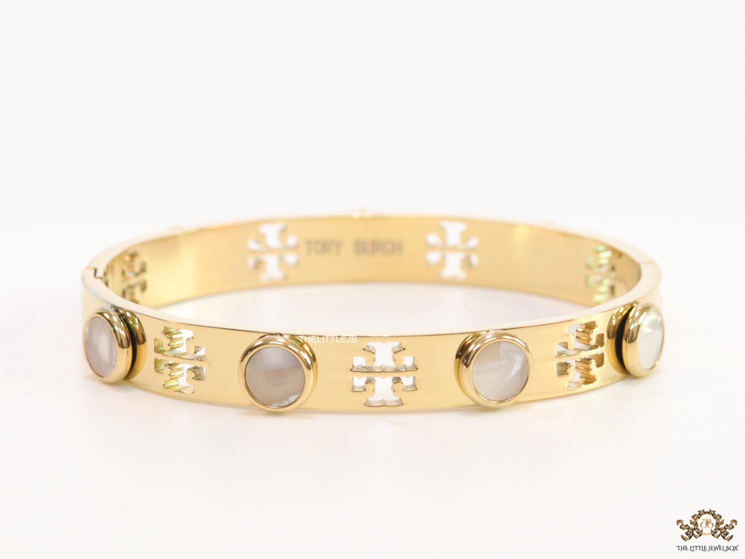 Gold plated cutwork twin T motif bracelet with white stones