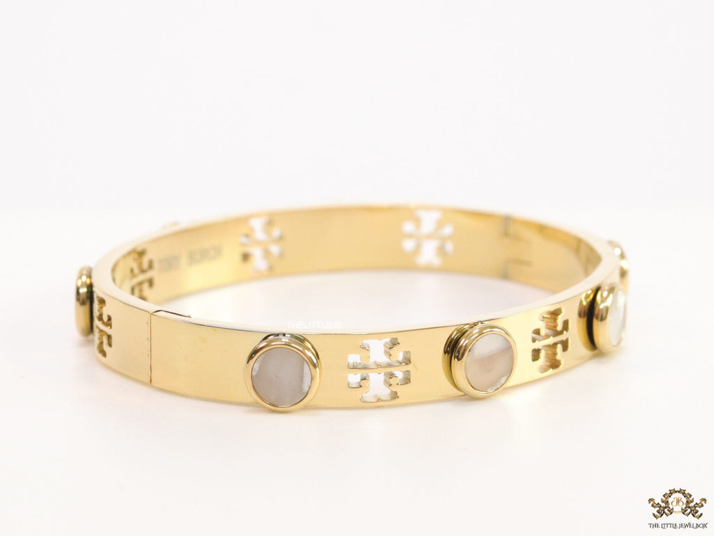 Gold plated cutwork twin T motif bracelet with white stones