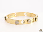 Gold plated cutwork twin T motif bracelet with white stones