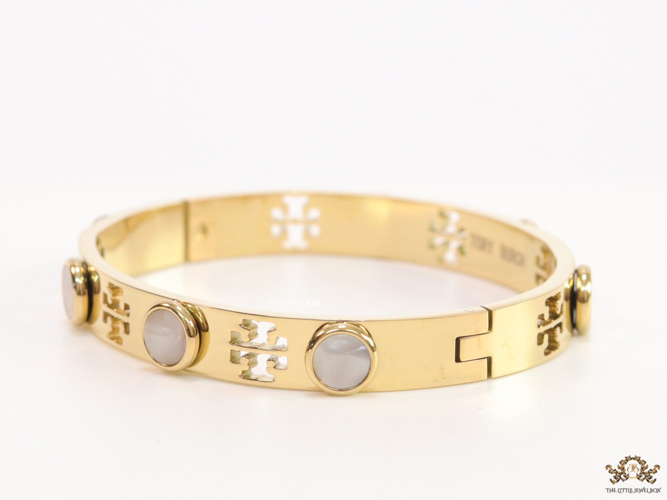 Gold plated cutwork twin T motif bracelet with white stones