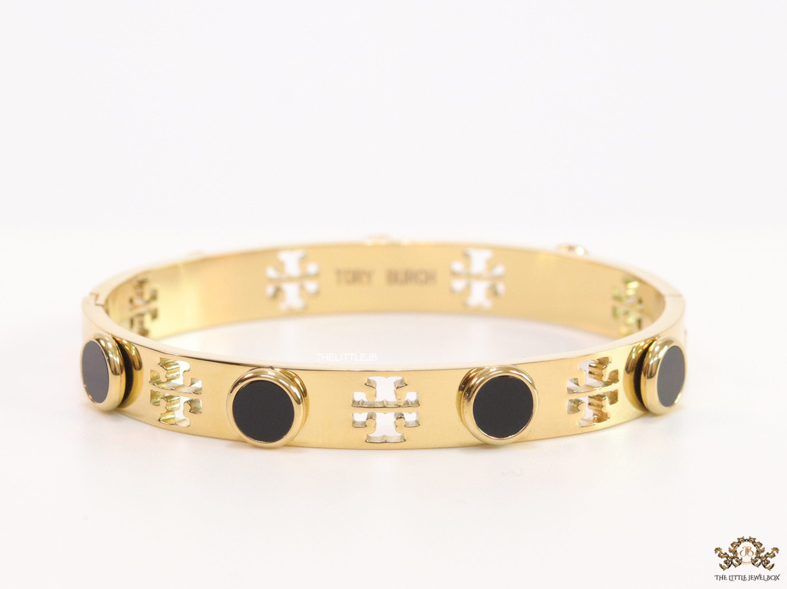 Gold plated cutwork twin T motif bracelet with black stones