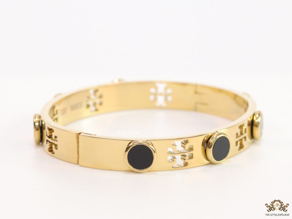 Gold plated cutwork twin T motif bracelet with black stones