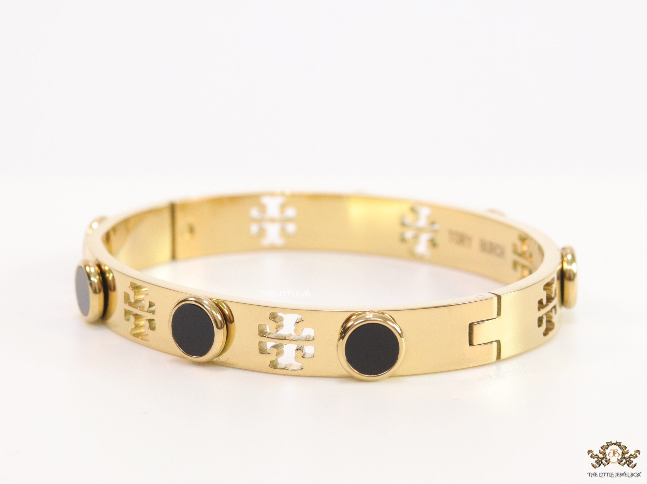 Gold plated cutwork twin T motif bracelet with black stones