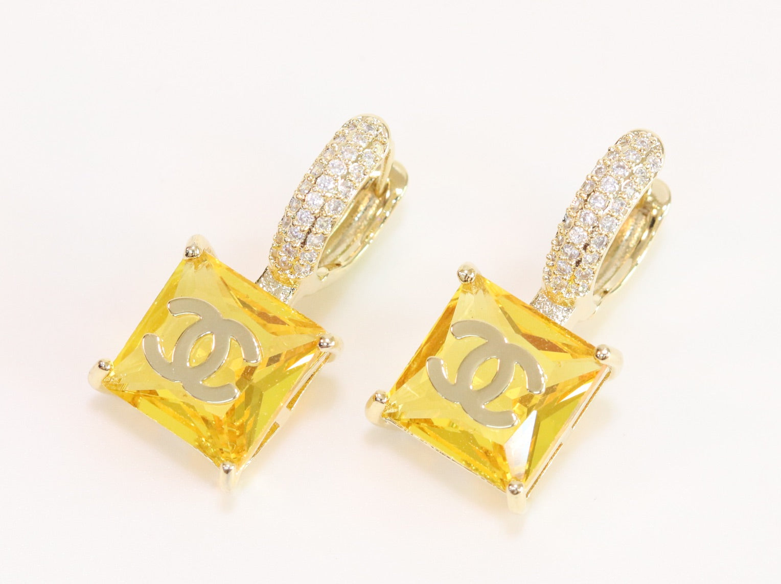 Double C on dangling yellow square gold earrings with CZ