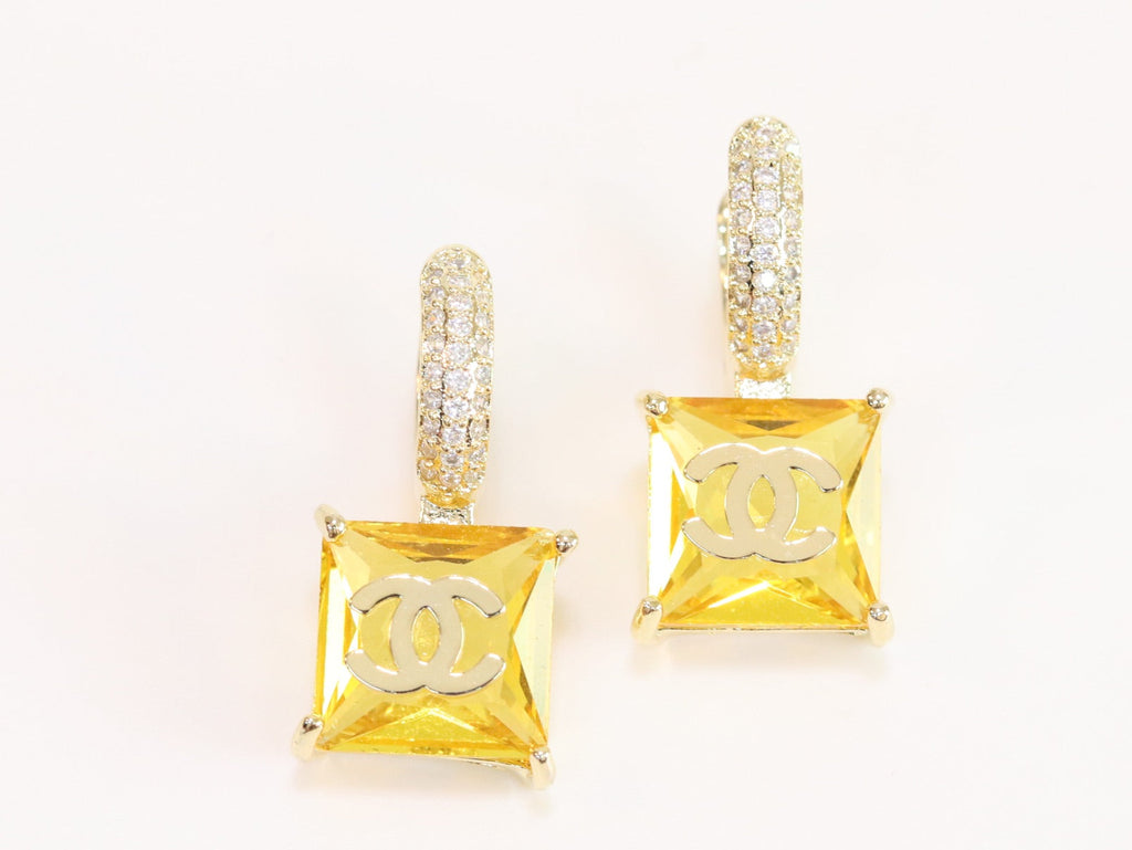 Double C on dangling yellow square gold earrings with CZ