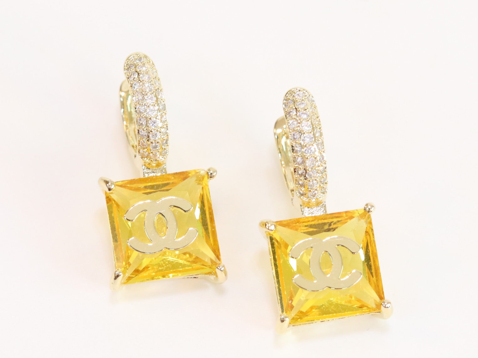 Double C on dangling yellow square gold earrings with CZ