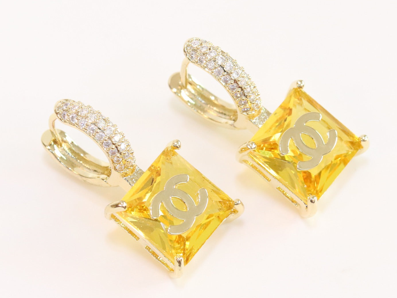 Double C on dangling yellow square gold earrings with CZ